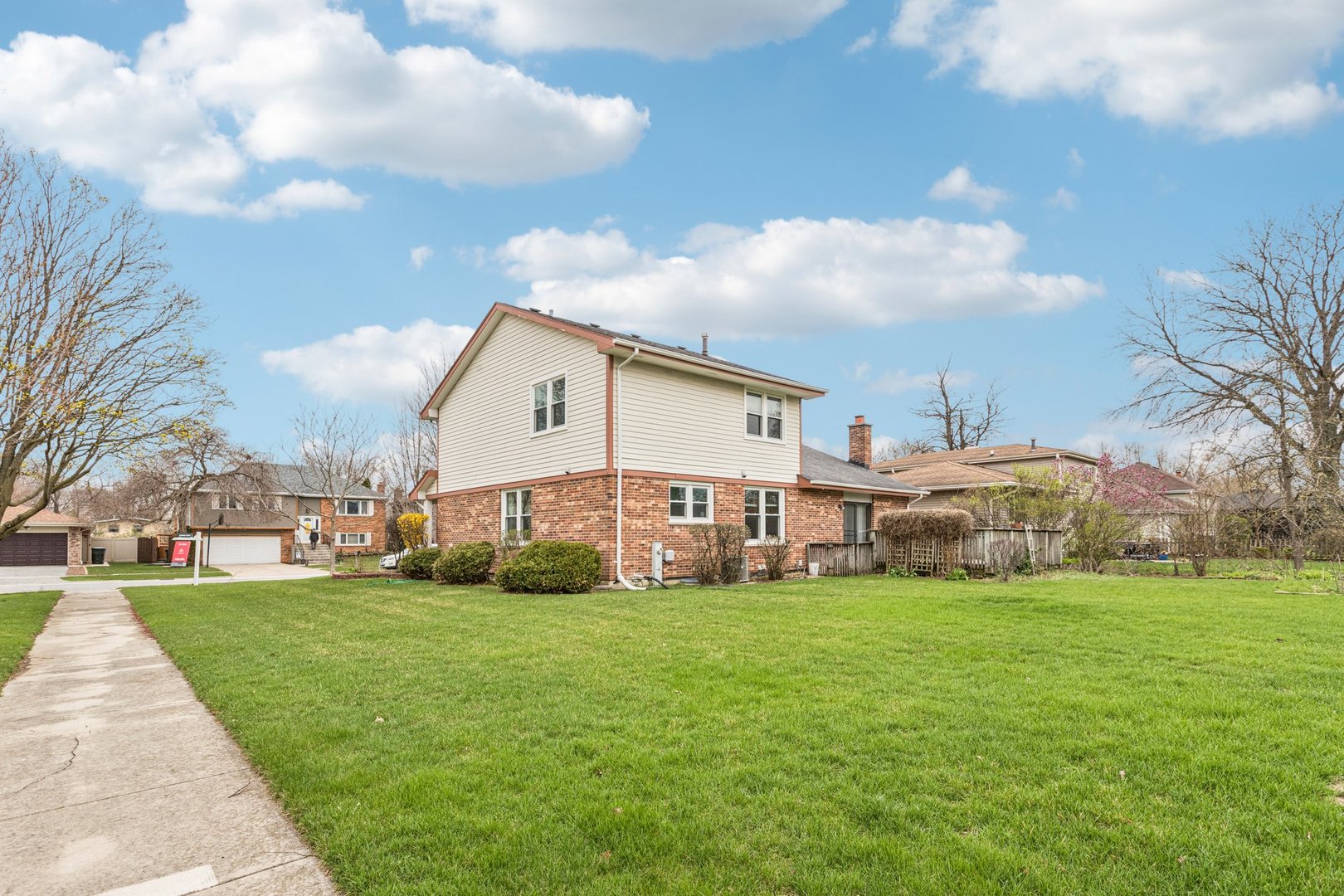18604 Carpenter Street Homewood, IL 60430 - Photo 25 of 31 a view of a house with a big yard and large trees
