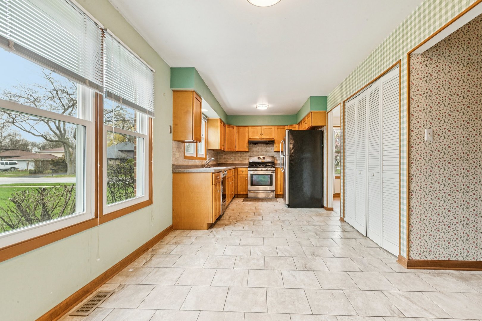 18604 Carpenter Street Homewood, IL 60430 - Photo 6 of 31 a kitchen with stainless steel appliances granite countertop a refrigerator and a stove