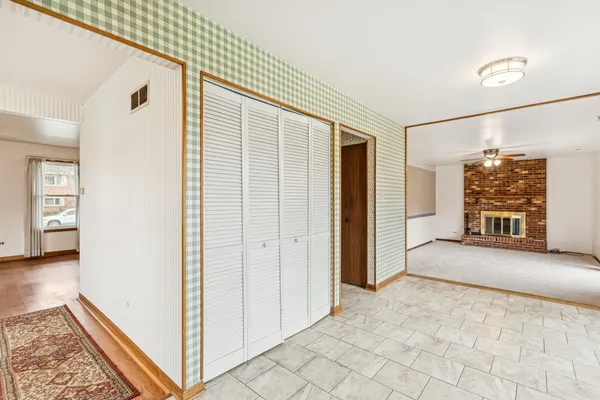 an empty room with fan and windows