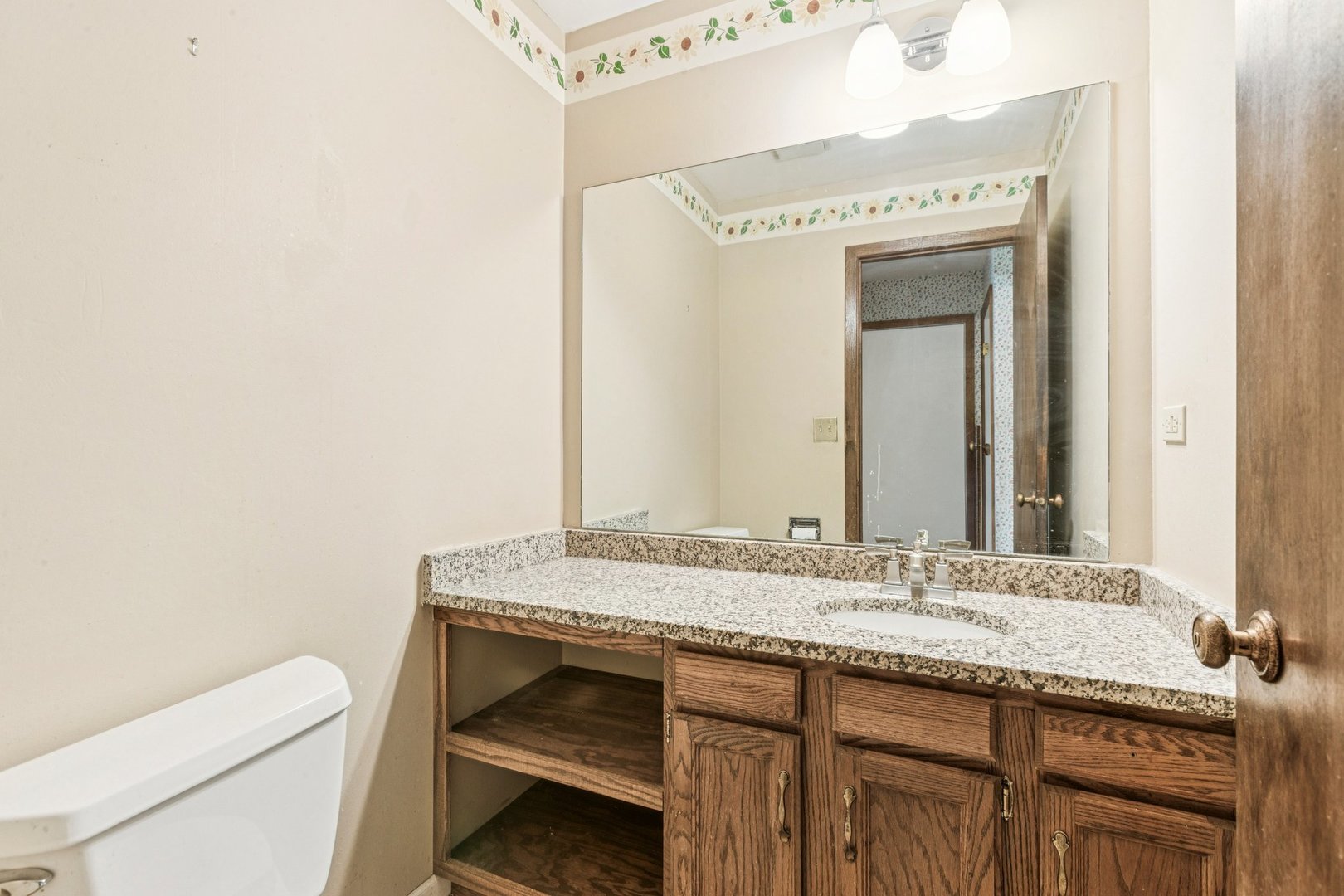 18604 Carpenter Street Homewood, IL 60430 - Photo 10 of 31 a bathroom with a granite countertop sink and a mirror