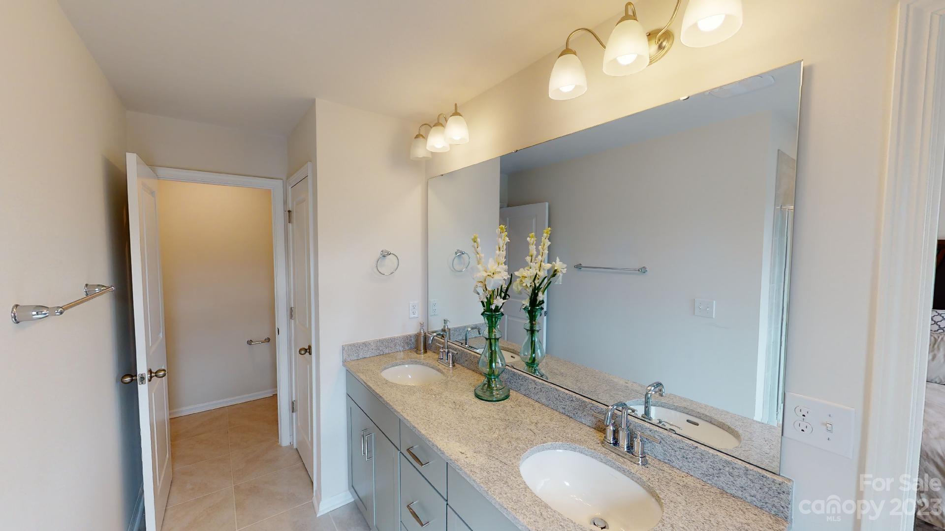 18 Ravens Rdg Road Hendersonville, NC 28792 - Photo 20 of 31 a bathroom with a granite countertop double vanity sink a mirror and shower