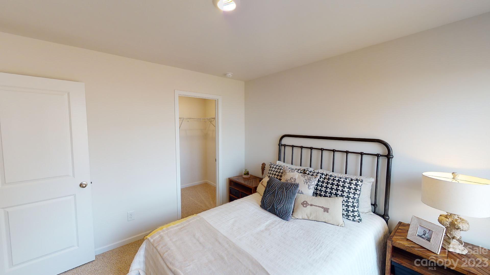18 Ravens Rdg Road Hendersonville, NC 28792 - Photo 24 of 31 a bedroom with a bed and a lamp on the dresser