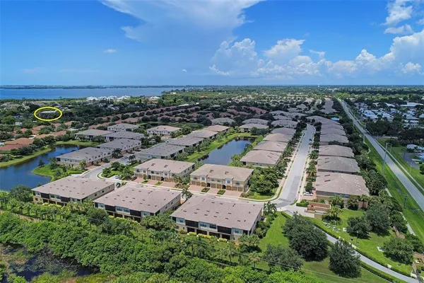 an aerial view of residential houses with outdoor space and street view