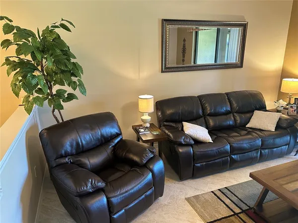 a living room with furniture and a lamp