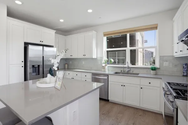 a kitchen with a sink stove and refrigerator