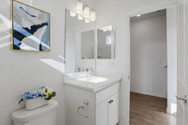 a bathroom with a sink vanity and a mirror