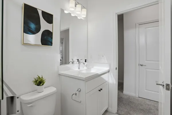 a bathroom with a sink a mirror and vanity