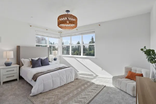a bedroom with a bed and a large window