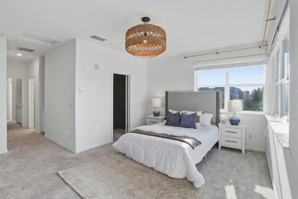 a bedroom with a bed and a large window