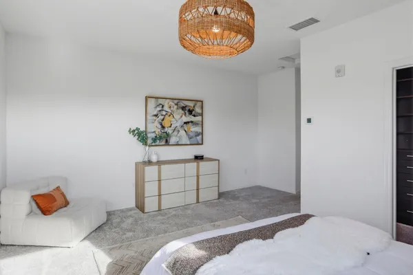 a bedroom with bed and cupboard