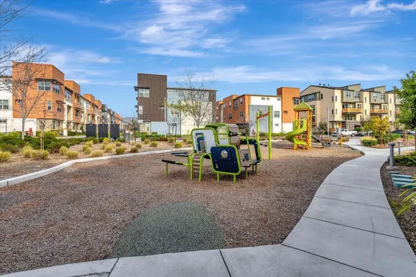 a view of a patio with couches and table and chairs and potted plants