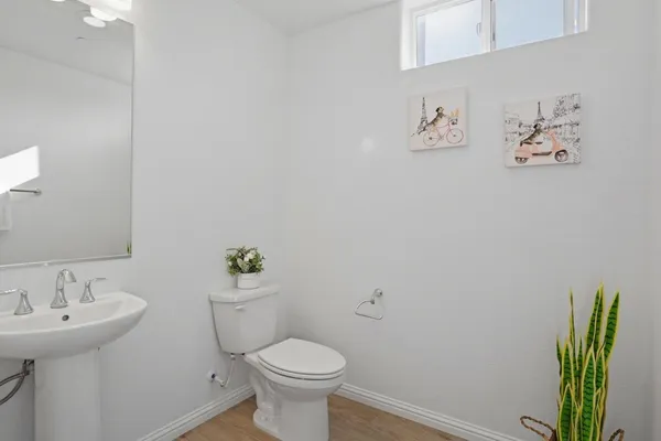 a bathroom with a sink mirror and toilet