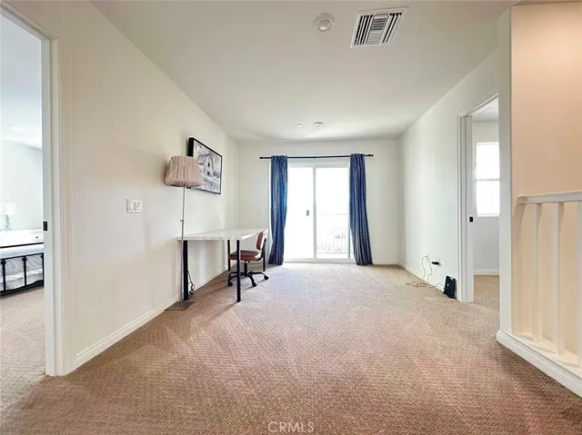 a view of a livingroom with a hardwood floor and a window