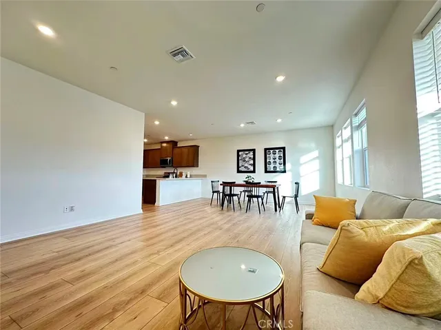 a living room with furniture and kitchen view