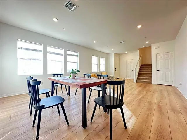 a view of a dining room with furniture window and wooden floor