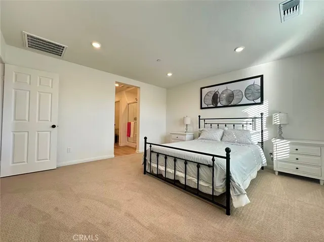 a spacious bedroom with a bed and window