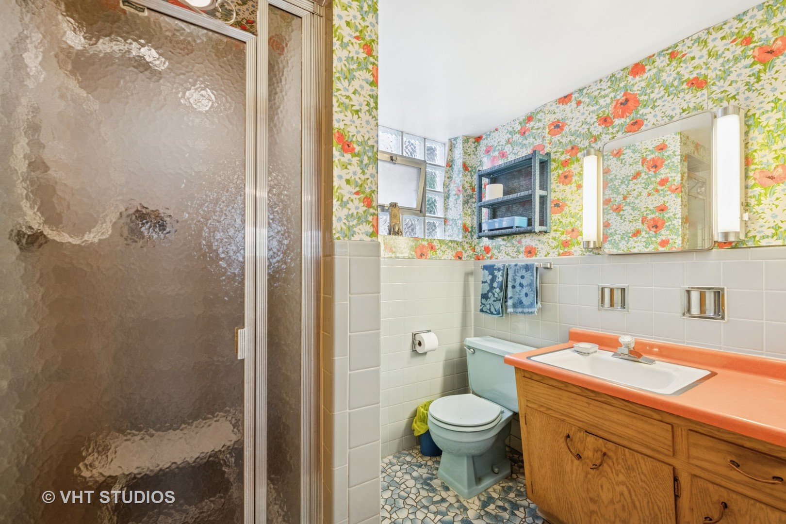 4143 West Devon Avenue Chicago, IL 60646 - Photo 12 of 22 a bathroom with a granite countertop sink a toilet and shower