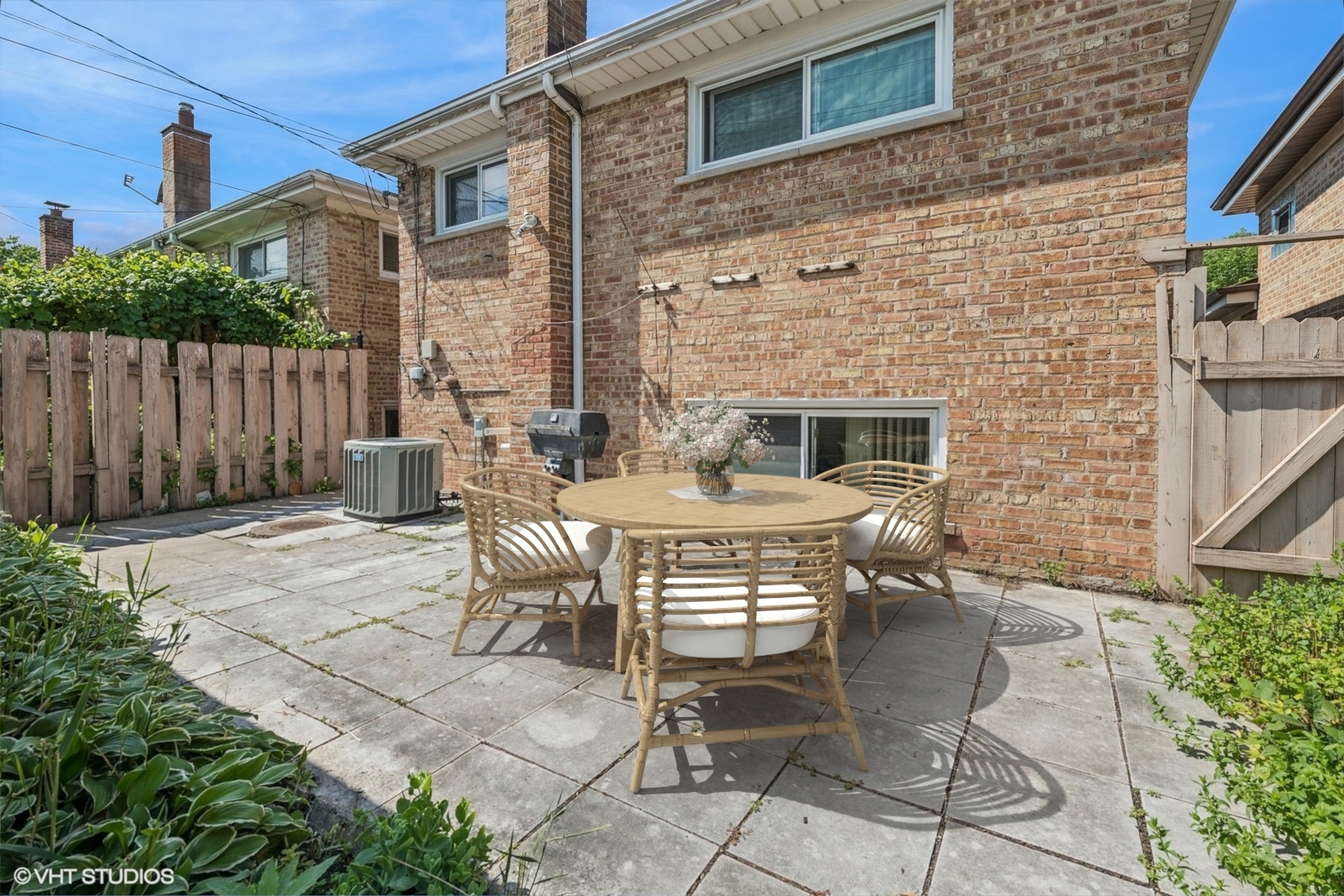 4143 West Devon Avenue Chicago, IL 60646 - Photo 16 of 22 a patio with table and chairs and potted plants