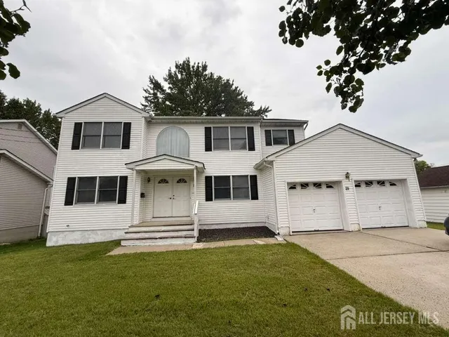 a view of a white house with large windows