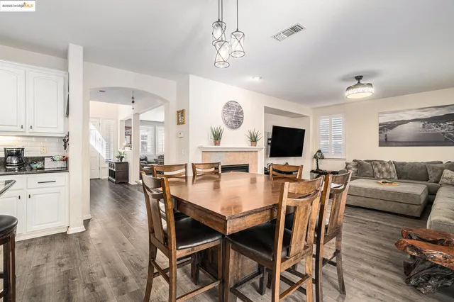 a view of a dining room with furniture and wooden floor