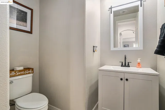 a kitchen with stainless steel appliances granite countertop a kitchen island a stove a sink a dining table and chairs