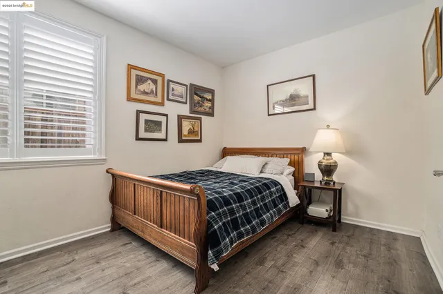 a bathroom with a toilet sink vanity and mirror