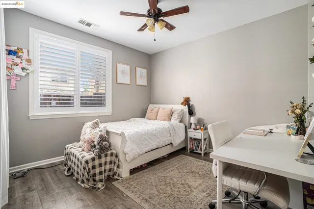 a bedroom with a bed and painting on the wall