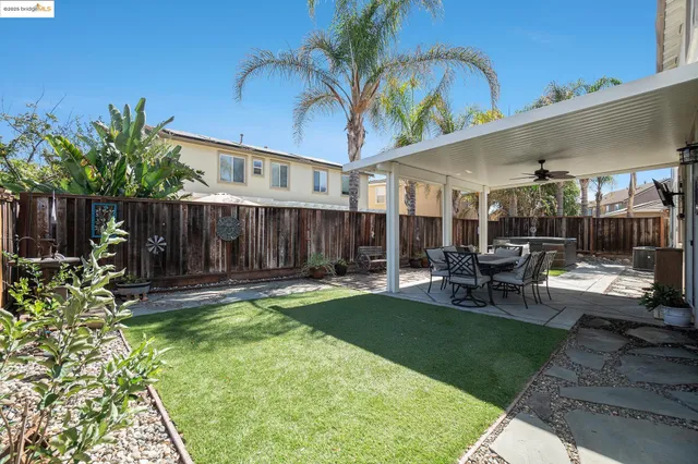 a view of a patio with a dining table and chairs