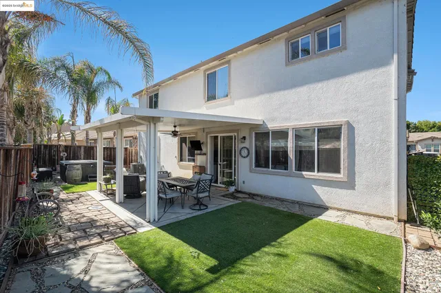 a view of a house with swimming pool and sitting area