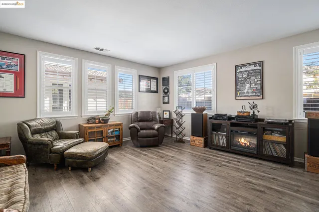 a living room with furniture window and wooden floor