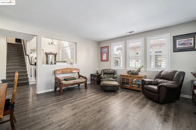 a bedroom with furniture and a large window