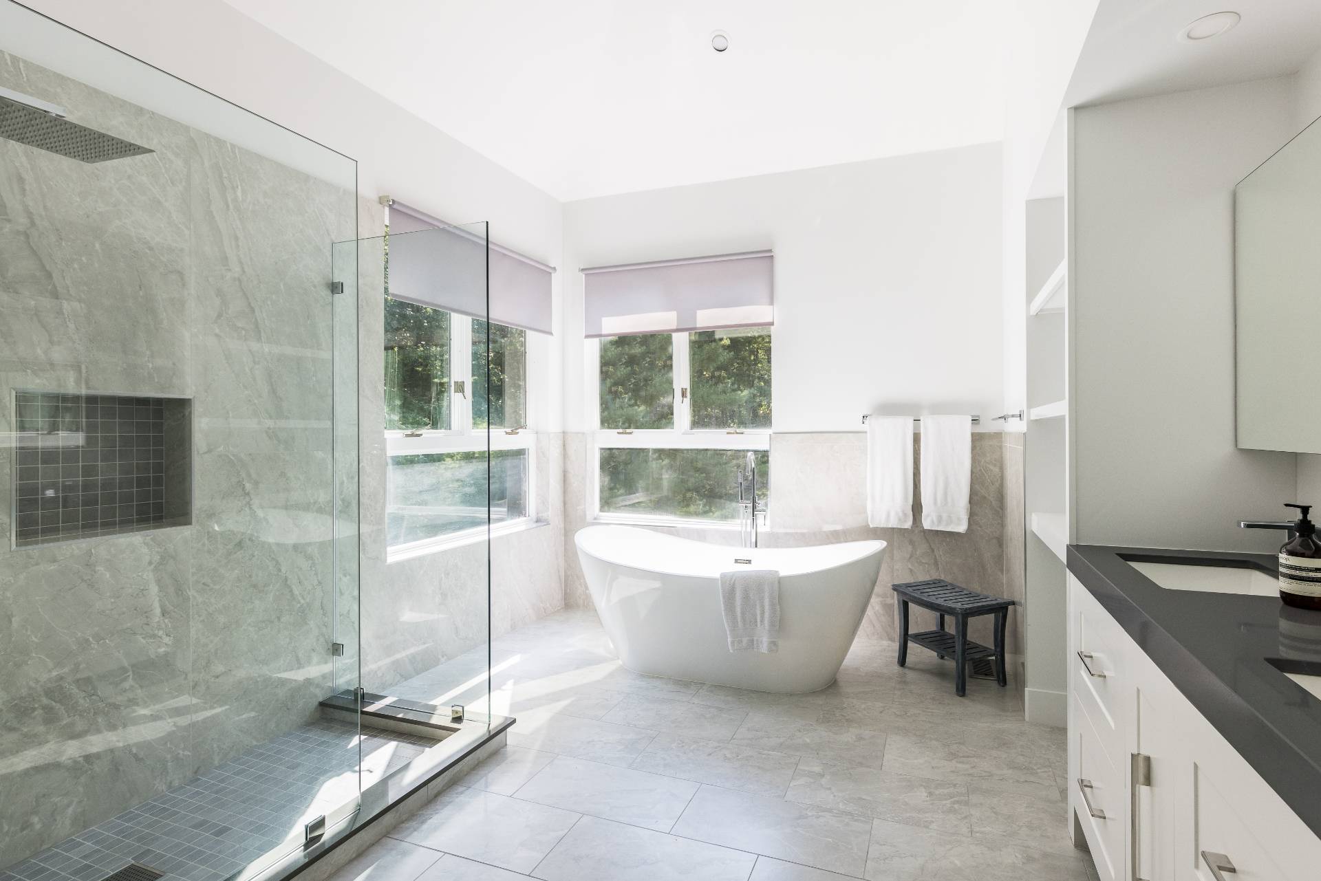 52 Bull Path East Hampton, NY 11937 - Photo 12 of 24 a spacious bathroom with a double vanity sink a mirror and a bathtub