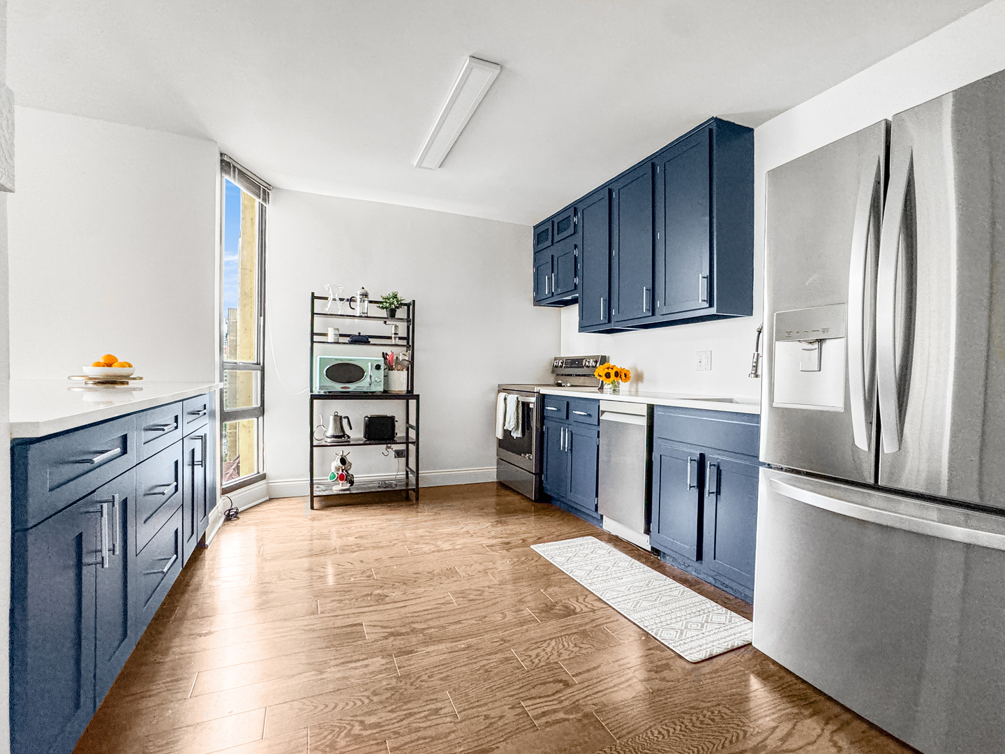 3150 North Sheridan Road, Unit 10C Chicago, IL 60657 - Photo 14 of 32 a kitchen with stainless steel appliances a refrigerator and a wooden floor