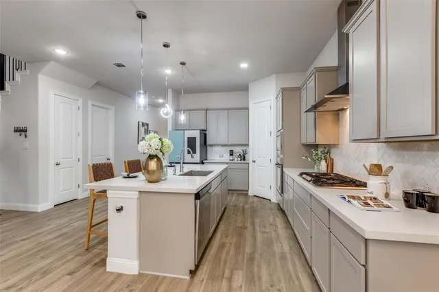 a kitchen with a sink stove and cabinets