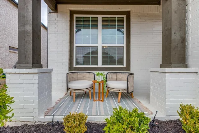 a view of a patio with table and chairs and potted plants