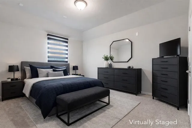 a bedroom with a bed and a dresser