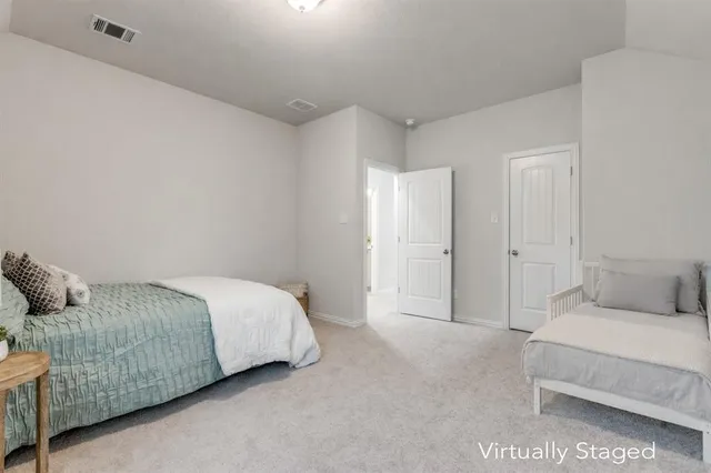 a spacious bedroom with a bed and a couch