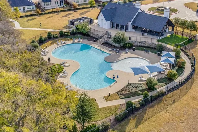 an aerial view of a house with a swimming pool