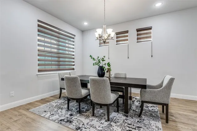 a view of a dining room with furniture wooden floor and chandelier