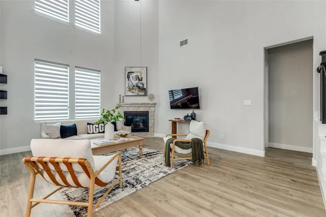 a living room with furniture a fireplace and a flat screen tv