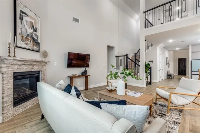 a living room with fireplace furniture and a flat screen tv