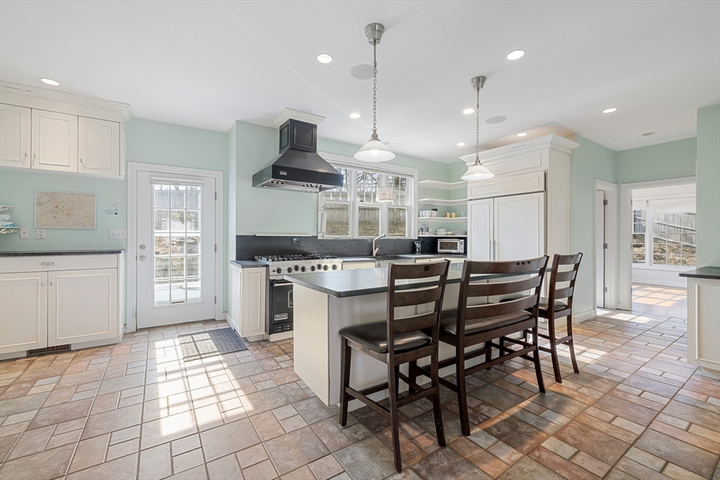 75 Cornell Road Marblehead, MA 01945 - Photo 7 of 26 a kitchen with stainless steel appliances kitchen island granite countertop a stove a sink a table and chairs in it