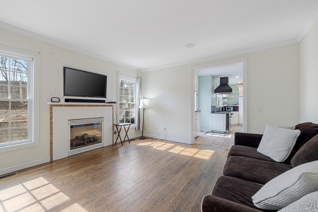 75 Cornell Road Marblehead, MA 01945 - Photo 10 of 26 a living room with furniture a flat screen tv and a fireplace