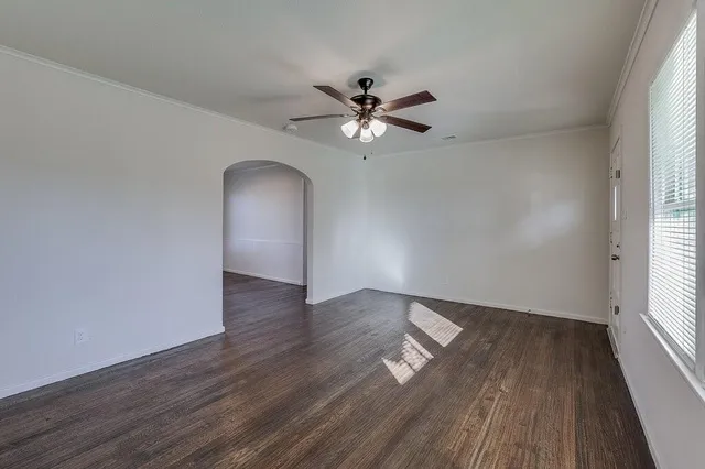 wooden floor in an empty room with a window