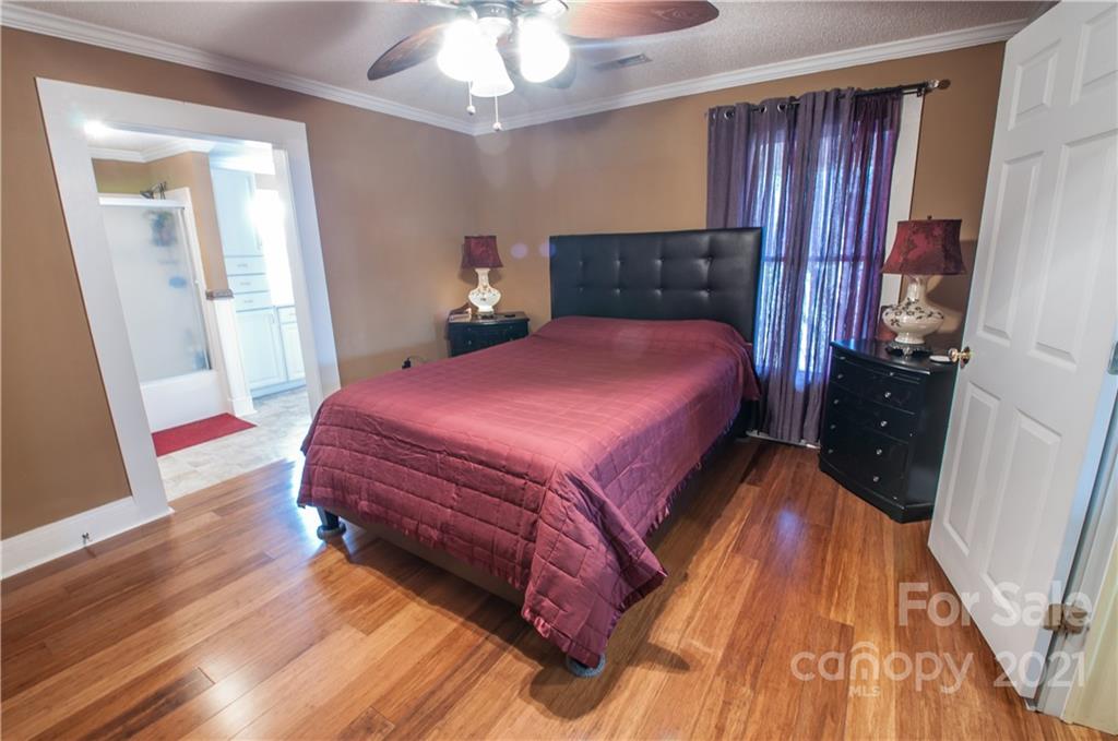 15655 Cool Springs Road Cleveland, NC 27013 - Photo 14 of 26 a bedroom with a bed and wooden floor