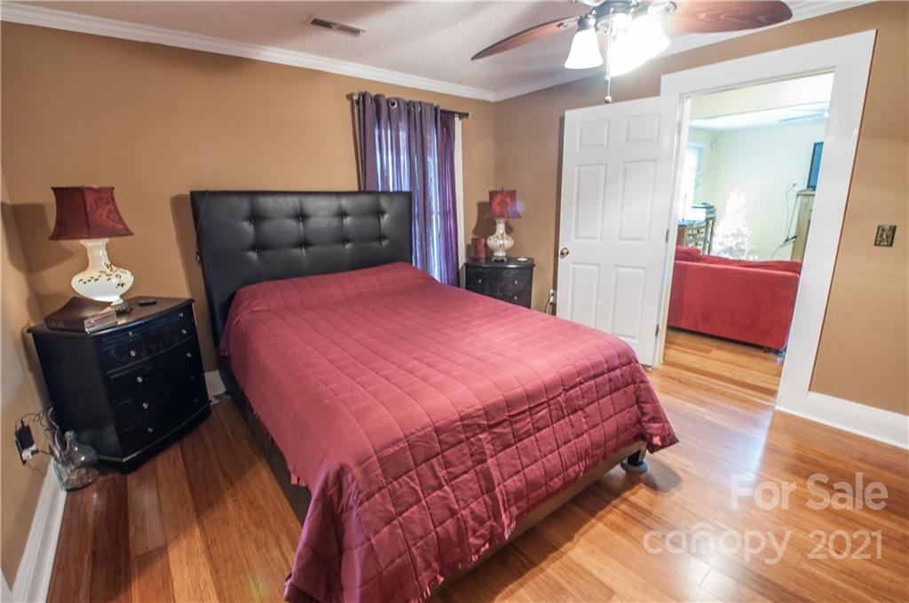 15655 Cool Springs Road Cleveland, NC 27013 - Photo 15 of 26 a bedroom with a bed and wooden floor