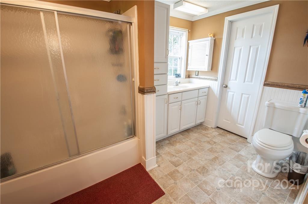 15655 Cool Springs Road Cleveland, NC 27013 - Photo 16 of 26 a bathroom with a sink a toilet and shower