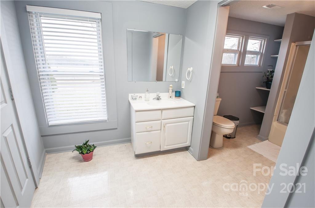15655 Cool Springs Road Cleveland, NC 27013 - Photo 20 of 26 a bathroom with a sink toilet and window