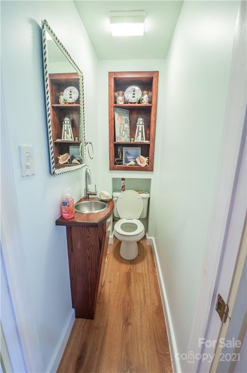 15655 Cool Springs Road Cleveland, NC 27013 - Photo 8 of 26 a room with a wooden floor and a potted plant