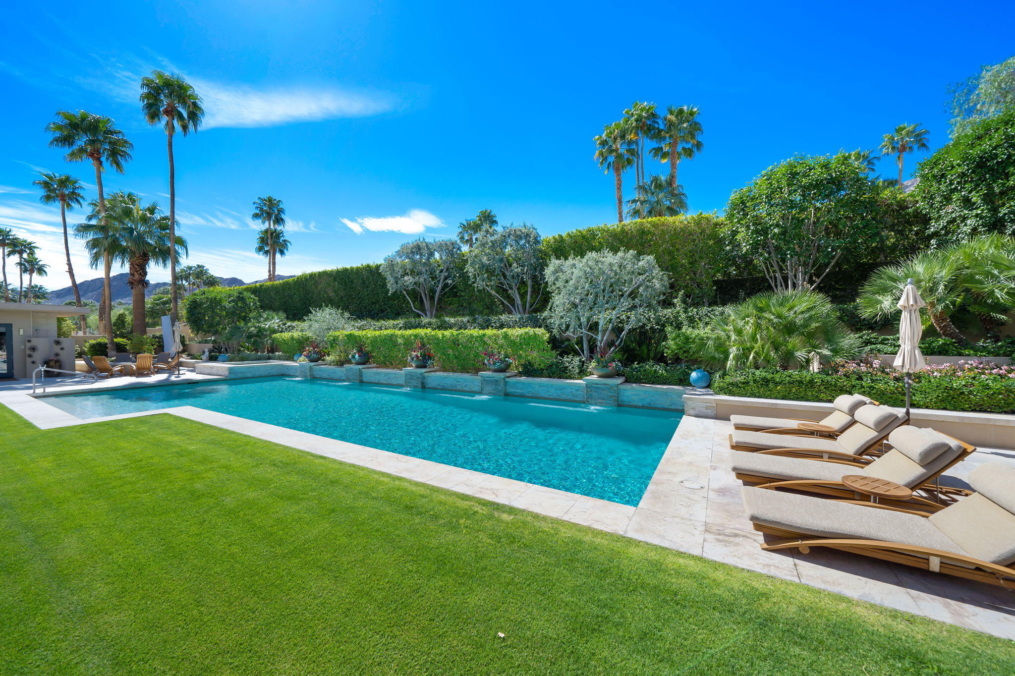 70345 Placerville Road Rancho Mirage, CA 92270 - Photo 108 of 116 a view of a garden with a bench in front of the house